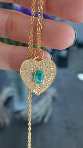 Diamond heart necklace with an emerald on a gold chain