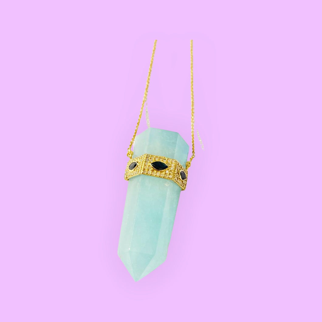 Aquamarine crystal pendant necklace with sapphire evil eye